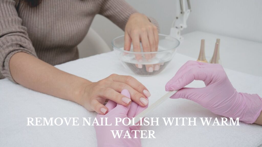 During a nail care manicure process, fingers are being dipped into a bowl of water for hydration and softening