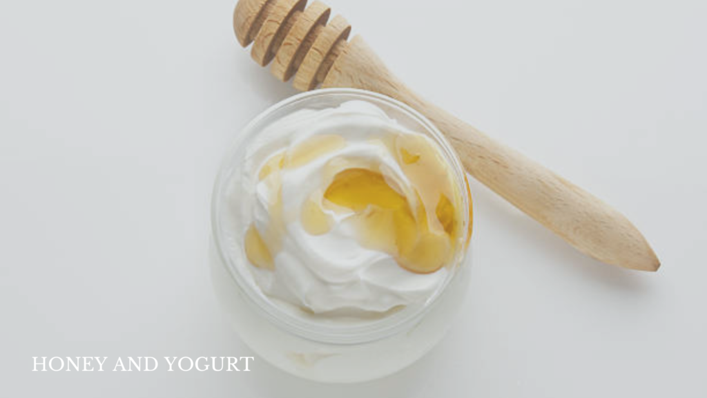 For Frizzy Hair- Top-down view of Greek yogurt drizzled with honey, displayed against a white background