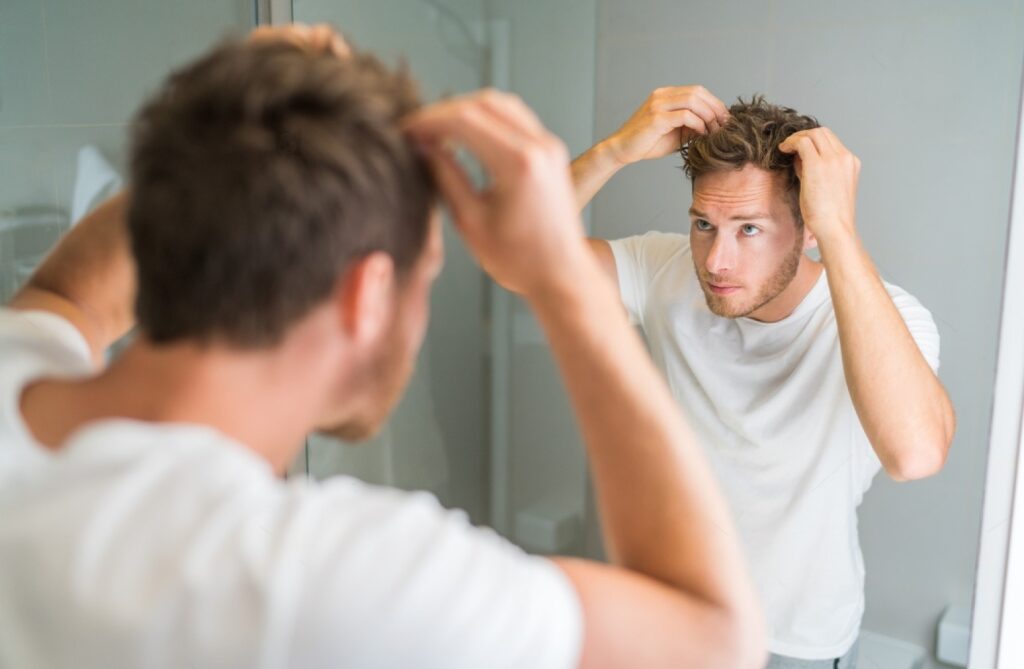 man checking scalp health