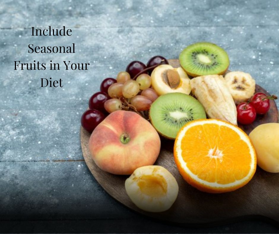 A wooden platter filled with fresh **seasonal fruits** rich in vitamins for a healthy diet